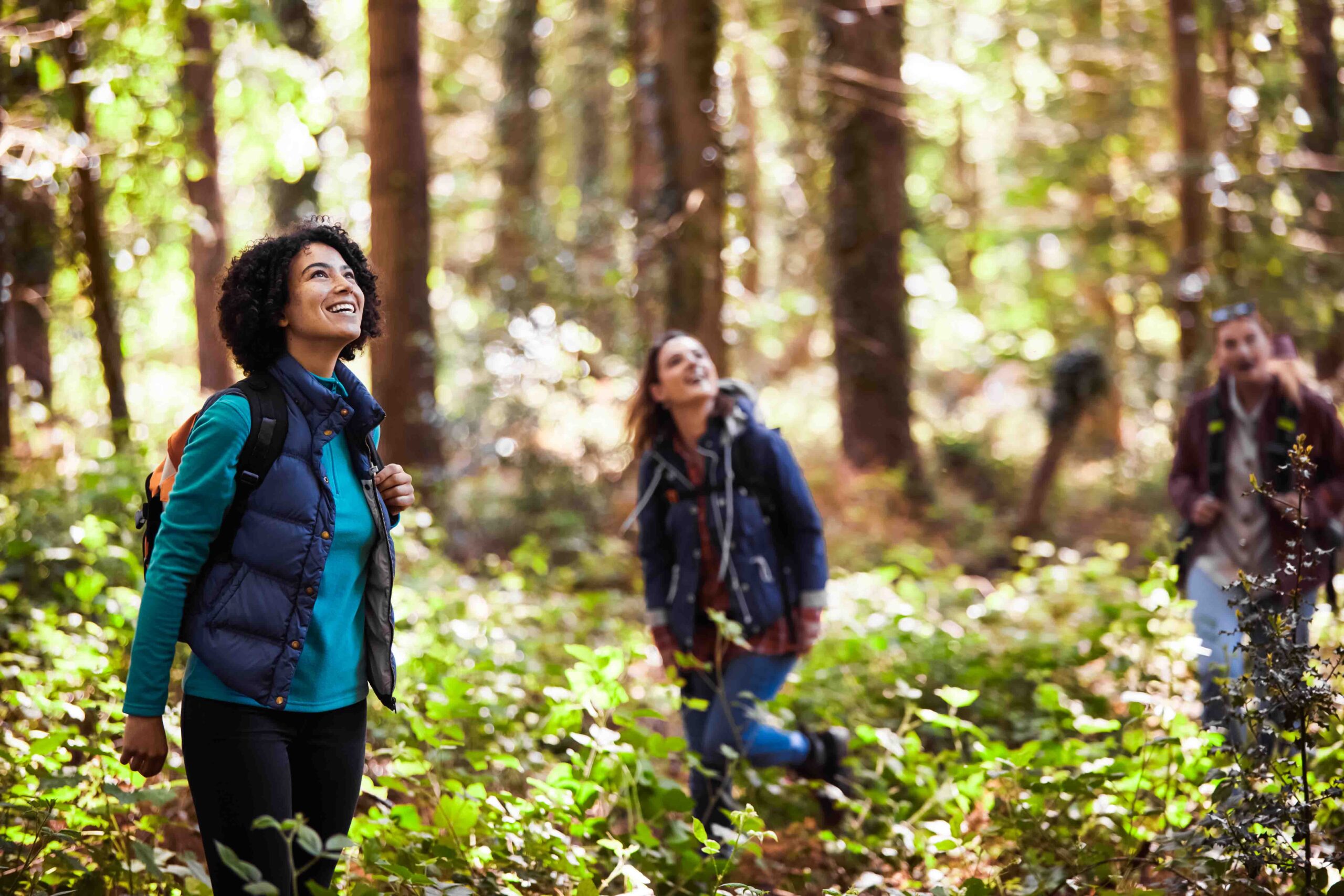 Group Of Young Female Friends On Camping Holiday Hiking Through