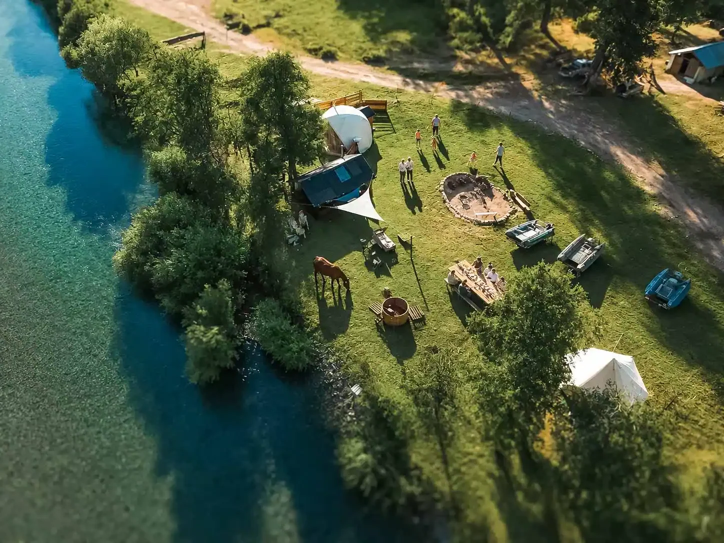 Aerial view of Rio Manso Lodge near Bariloche with guests fly casting, dining and horseback riding in Patagonia
